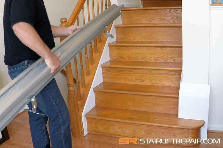 Technician removing a stairlift rail
